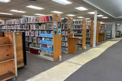 Adult section with new carpet and paint with shelves and books back in place, closer view