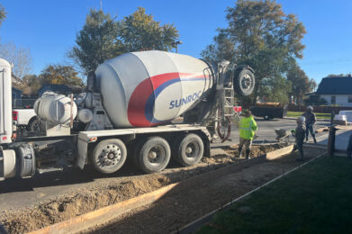 Sidewalk formed with concrete truck ready to pour.